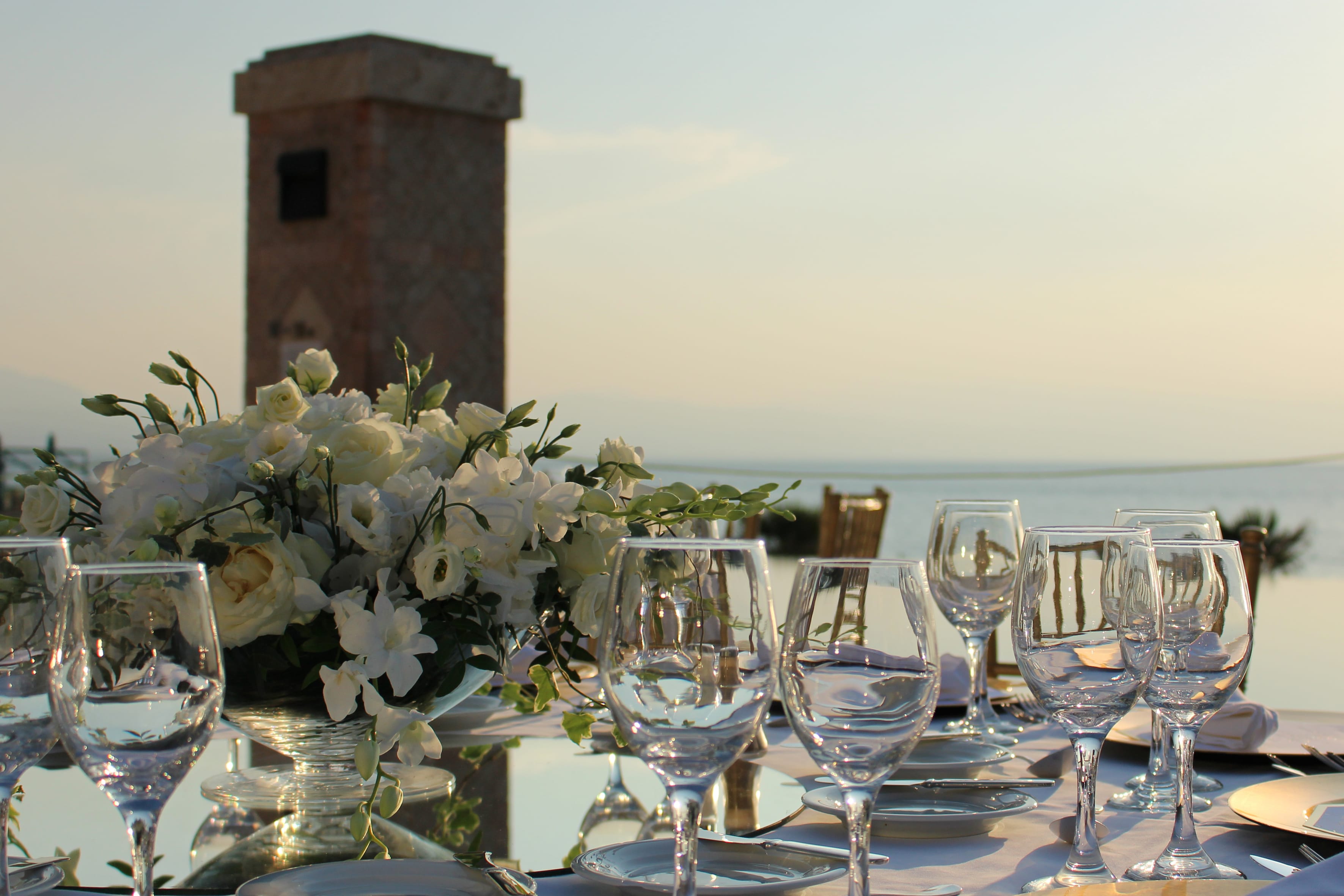 a table with glasses and flowers