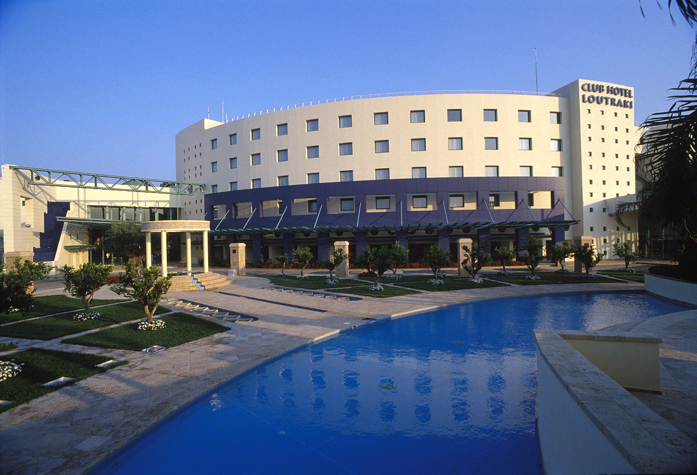 a large building with a pool in front of it