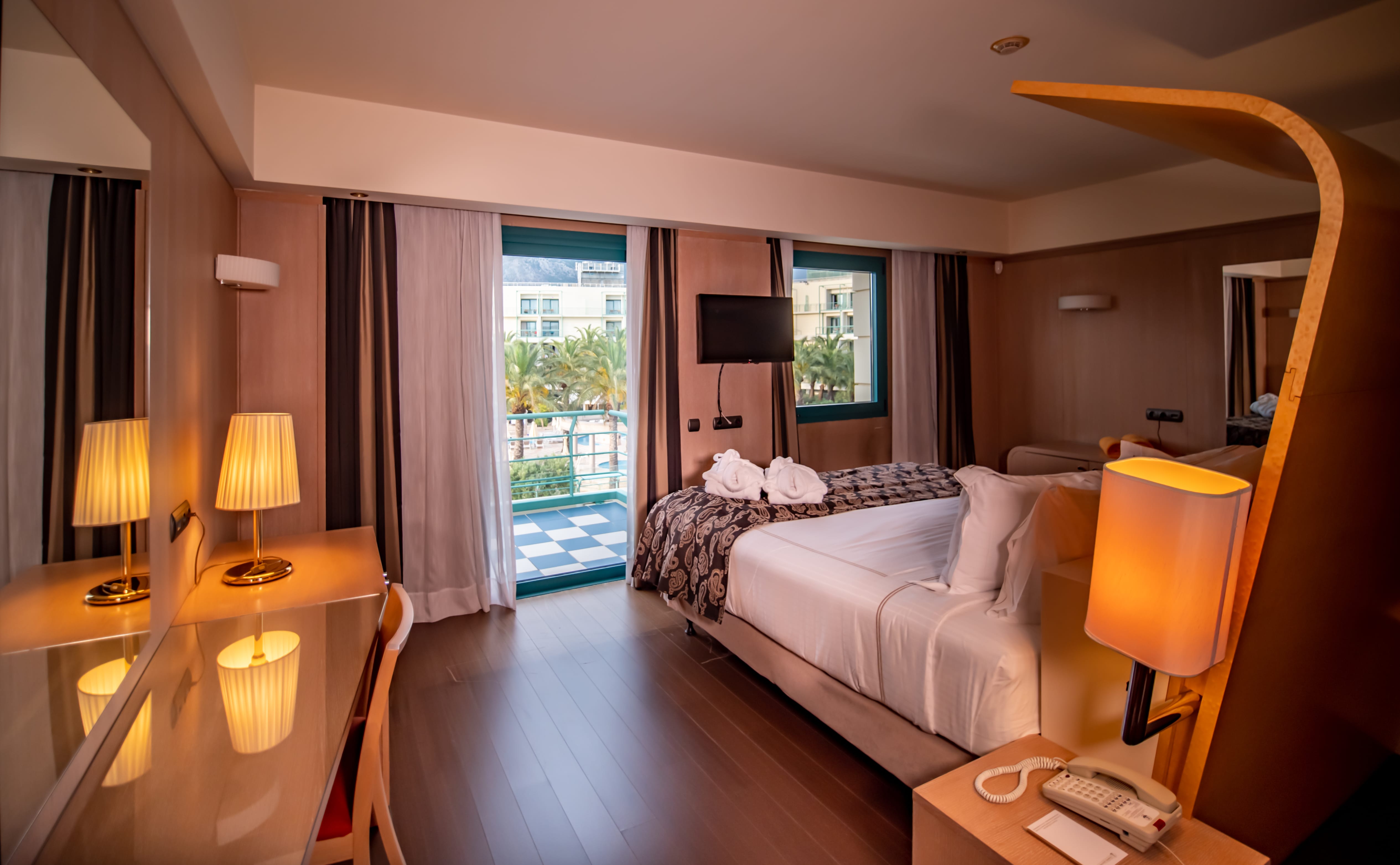 a hotel room with a bed and lamps